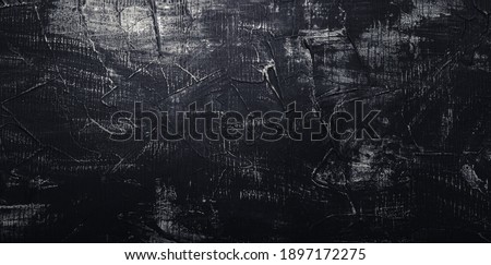 Black concrete wall. Texture old dark stone background. Vintage anthracite wallpaper. Old scratched dark grunge plaster texture. Black cement background with white scuffs. Long Web banner Royalty-Free Stock Photo #1897172275