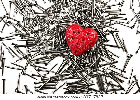 Love heart on pile of iron grey nails