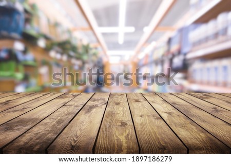 Blank wooden table top with blur background.