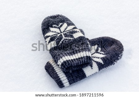 knitted mittens on soft fluffy snow