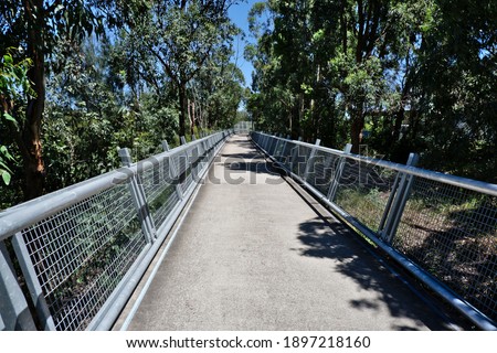 Walk and cycle ways made from metal and raised above the tidal marsh land along the Parramatta river Royalty-Free Stock Photo #1897218160