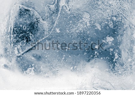 Ice texture background. Textured cold frosty surface of ice block on dark background. Royalty-Free Stock Photo #1897220356