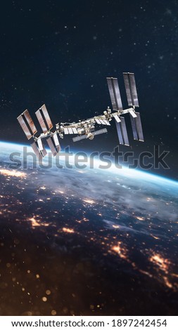 International space station on orbit of Earth. View from outer space. ISS. Vertical wallpaper. Elements of this image furnished by NASA.