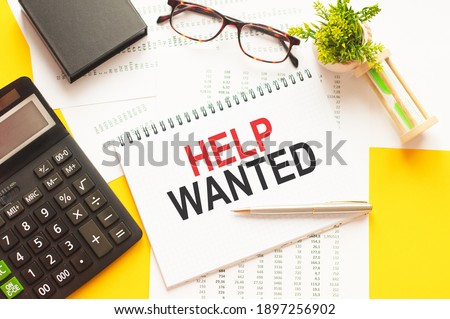 Writing text showing HELP WANTED. Writing text HELP WANTED on white paper card, red and black letters, yellow background. Business concept. .