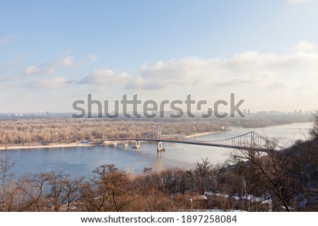 Bridge over the river in the city in early spring, view from above
