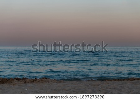 sea background of pastel sunset skies glowing above tranquil turquoise blue horizon
