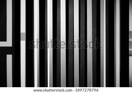 Close-up photo of white vertical blinds on window. Striped structure. Abstract geometric background of interior design, modern architecture, industry or technology. Stripes and parallel lines.