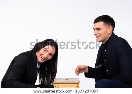 Business partners chatting, competing and laughing on a white background with blank space. The concept of gender stereotypes.