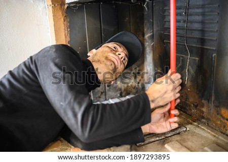 Young chimney sweep at work Royalty-Free Stock Photo #1897293895