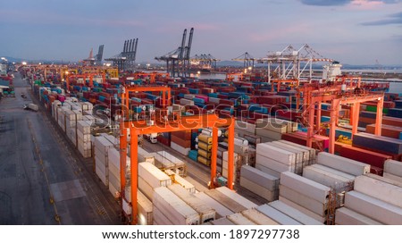 Smart crane loading cargo container to container truck in the international terminal logistic depot sea port  concept freight shipping transportation and service concept.