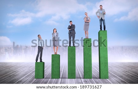 Composite image of business people standing on bar chart depicting growth
