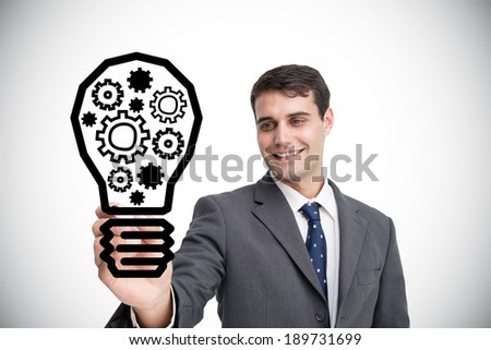 Composite image of businessman drawing light bulb against white background with vignette