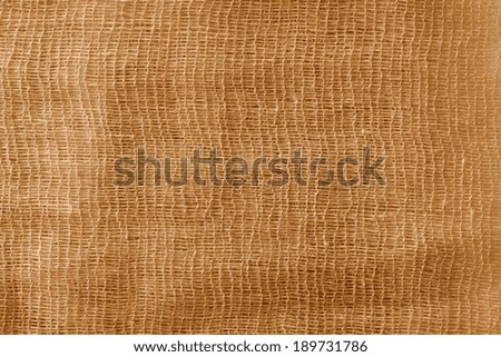 the bright abstract color texture of a gauze is painted in  brown color