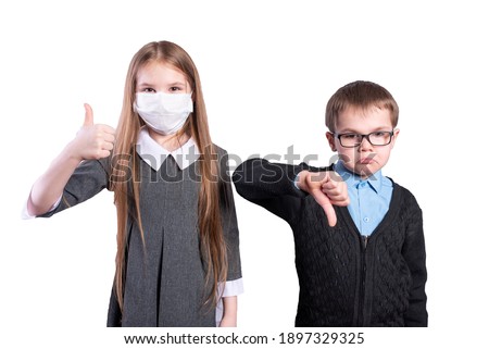 A girl in a mask shows well, a boy without a mask shows badly. Isolated on white background. High quality photo
