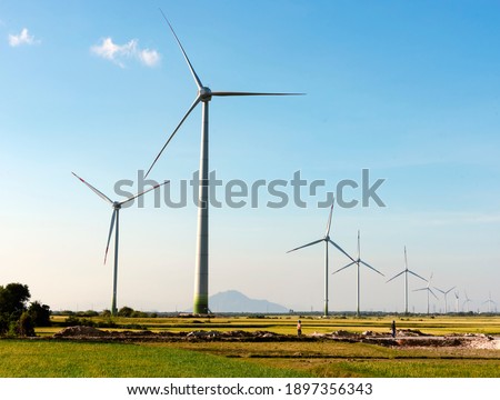 Wind turbine tower construction with beautiful landscape and blue sky to generate clean renewable green energy for sustainable development to prevent climate change and global warming to protect earth Royalty-Free Stock Photo #1897356343