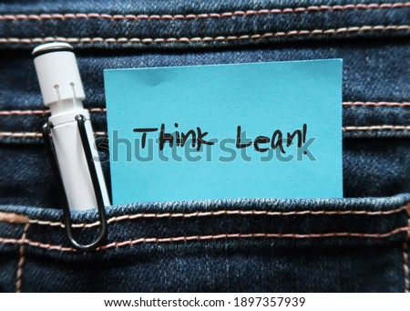 Pen and blue note in jeans pocket written THINK LEAN , a goal to creating most value to customer at minimum cost by minimizing resources , time , energy and effort Royalty-Free Stock Photo #1897357939
