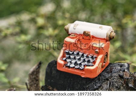 Hand home made model. Steampunk style future Typewriter on nature background.