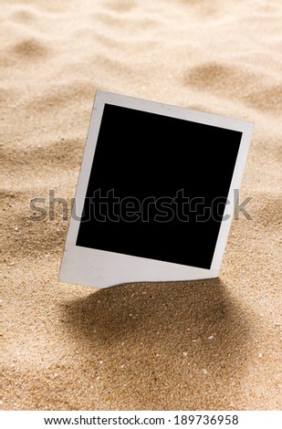 Old style empty photo cards on a sea sand. Sunny summer background 
