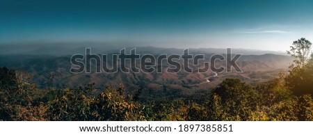 scenic landscape of mountains and mist at sunset time in Nan Province, Thailand.