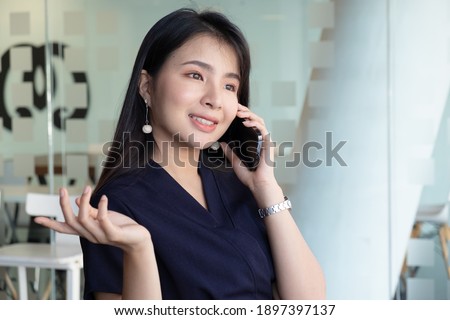 Businesswoman talking on the phone while working at worktable in the office.