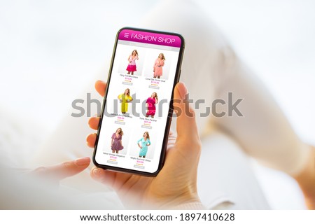 Woman browsing fashion store online and choosing a new dress