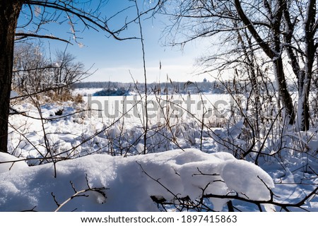 Spacious snow landscape. River and hills in Russia, white winter on the terrain, a lot of fluffy snow and ice