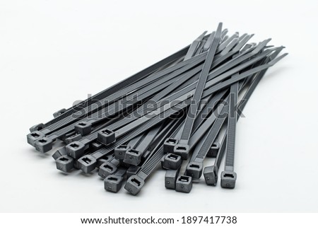 Grey plastic cable ties isolated on a white background Royalty-Free Stock Photo #1897417738