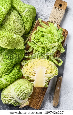Sliced Savoy cabbage from organic grower farm. White background. Top view. Royalty-Free Stock Photo #1897426327