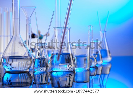 Chemical experiment concept. Laboratory equipment. Blue background. Royalty-Free Stock Photo #1897442377