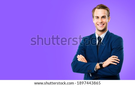 Portrait of businessman in blue suit and tie, with crossed arms, isolated over purple violet color background. Business concept. Smiling man at studio picture. Copy space for some text.