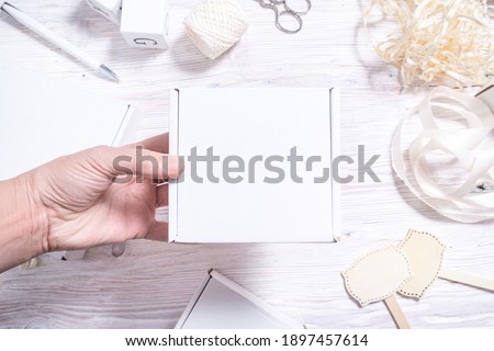 White cardboard carton box on wooden desk, flat lay mock up 