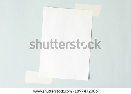 One sheet of paper crookedly pasted on the wall. White sheet mock up, copy space.