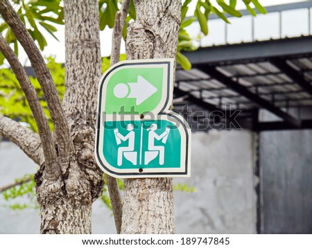 Toilet sign art on trees