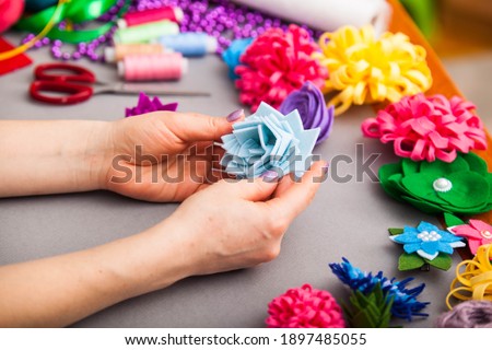 Woman modelling artificial flower from clay