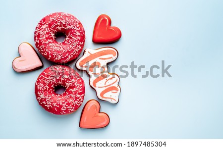 
International Women's Day. 8 march number eight, consisting of donuts beside a cookie cutter
 with an inscription
 love on stone background with place for text