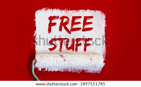 FREE STUFF.One open can of paint with white brush on red background.
