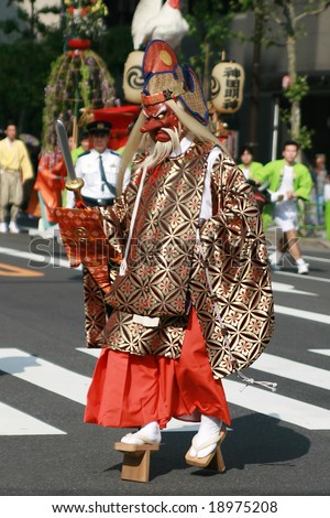 A traditional character from Japan, a tengu, walks in the street