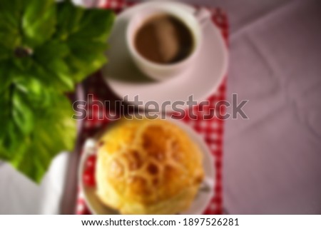 blurred soup with cherry and a cup of coffee