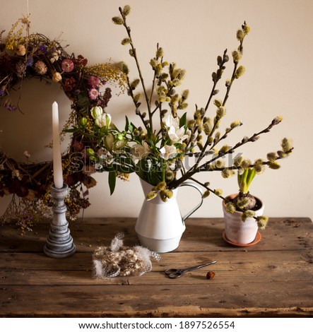 spring,easter composition 
 jug  with willow branches and  flower alstroemeria,candlestick,bird nest,cup of tea.