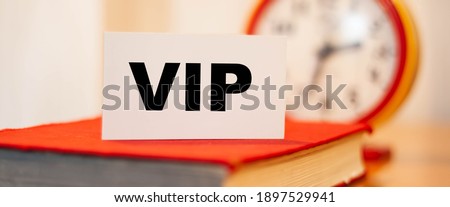 VIP business card for entering the event for honored guests against the background of the clock