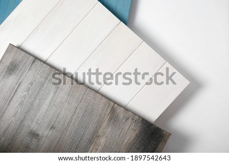 Different wooden surfaces for photography on white background, top view