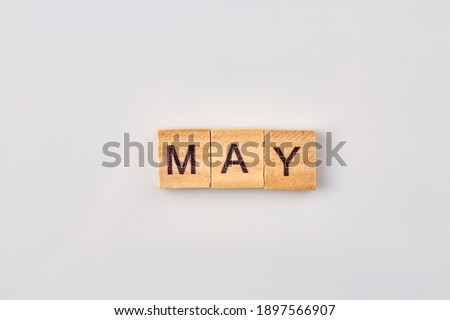 May word written on wood blocks. Isolated on white background.