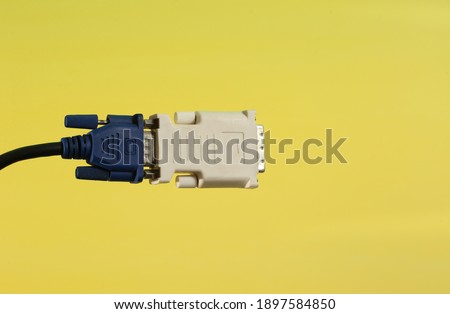 Computer component wire cable with its adapter isolated on yellow background with copy space