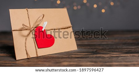 Love letter with a heart on a background of lights, love and valentine concept on a wooden table