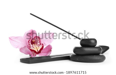 Incense stick in holder near orchid flower and spa stones on white background Royalty-Free Stock Photo #1897611715