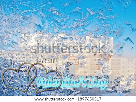 Frosty patterns on the window for Valentine's Day - February 14. Conceptual background with space for greeting text. The atmosphere of the lovers ' holiday. Holiday card