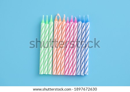 Colorful candles isolated in blue background