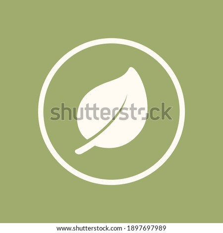 A leaf in a circle logo icon isolated element on a green background. Simple flat clip art vector graphic design. Sign or symbol for nature, plants, eco friendly organic products, vegetarian menu, etc.