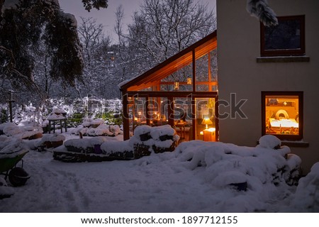 A warm welcome at dusk at the Dales farm cottage in evening snow Royalty-Free Stock Photo #1897712155