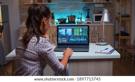 Young sound engineer working on video footage during post production. Content creator in home editing on montage of film using modern software for processing late at night.